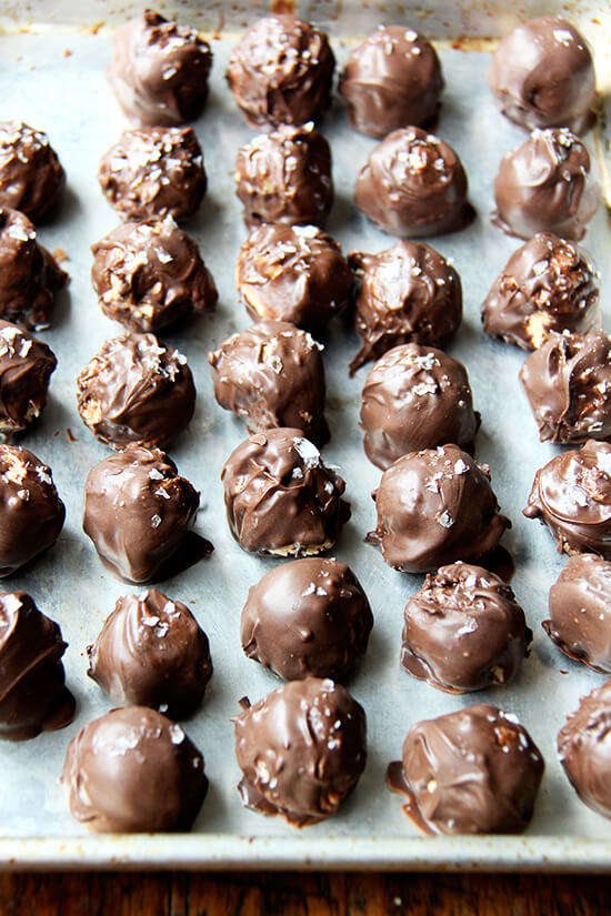 Chocolate peanut butter truffles on a sheet pan.