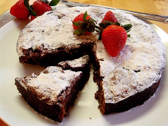 This rich Passover chocolate cake rises dramatically, cracks and then falls. When dusted with Passover “confectioners’ sugar” and garnished with berries, the cake looks striking on the table. // alexandracooks.com This rich Passover chocolate cake rises dramatically, cracks and then falls. When dusted with Passover “confectioners’ sugar” and garnished with berries, the cake looks striking on the table. // alexandracooks.com