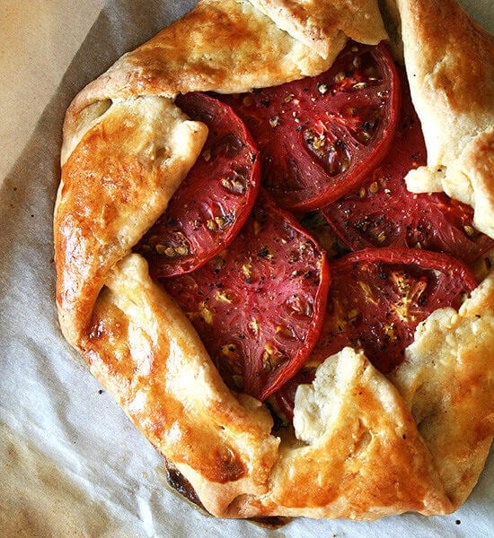 A sheet pan with two freshly baked savory galettes.