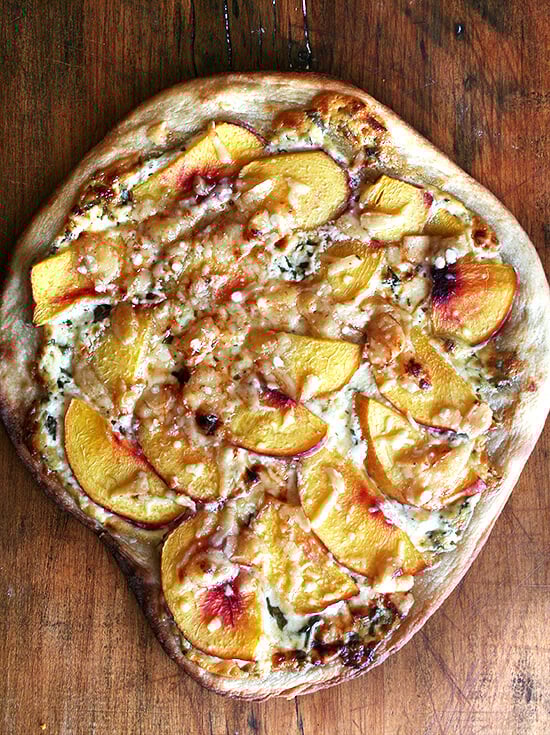 Just baked nectarine pizza on a board. 