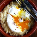 A bowl of fresh corn polenta with a poached egg on top.
