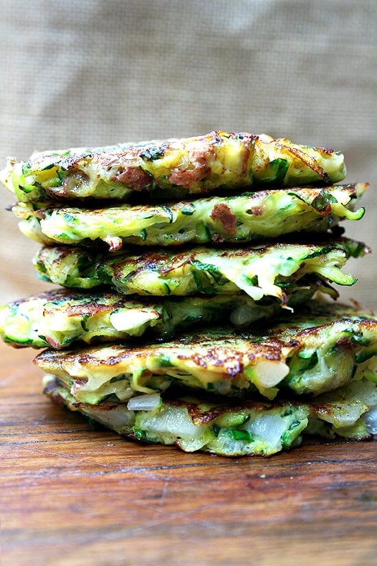A combination of grated zucchini and potato with a little diced onion give these zucchini fritters a lovely latke texture. But the addition of lemon zest and lots of herbs give them a freshness and lightness that's irresistible. // alexandracooks.com A stack of zucchini fritters