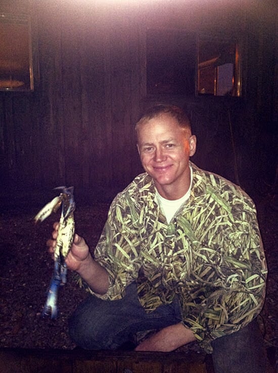 husband Ben holding a soft shell crab.