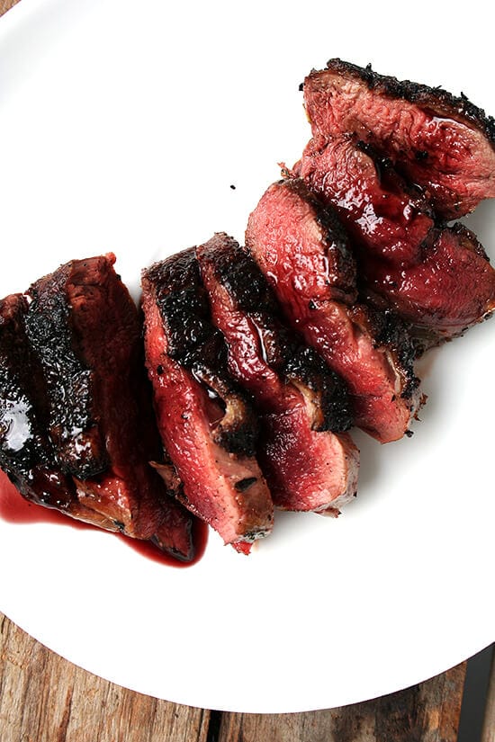 This Sally Schneider recipe for seared duck breasts with port wine reduction is a good one to have in your repertoire — it's simple yet it's bistro quality. This is a perfect dish for a date night at home. // alexandracooks.com An overhead shot of a plate of seared wild duck breasts with port wine sauce.