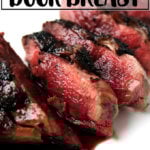 Pan-seared and sauced wild duck breast on a plate.