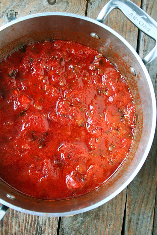 In this tomato sauce, canned tomatoes are brightened by olive oil and sautéed onions, a few cloves of crushed garlic, a little white wine, some chopped fresh parsley, and a pinch of crushed red pepper flakes. After about 20 minutes of simmering, it's done. And it's delicious. // alexandracooks.com In this tomato sauce, canned tomatoes are brightened by olive oil and sautéed onions, a few cloves of crushed garlic, a little white wine, some chopped fresh parsley, and a pinch of crushed red pepper flakes. After about 20 minutes of simmering, it's done. And it's delicious. // alexandracooks.com
