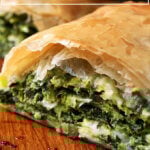A halved spanakopita strudel.