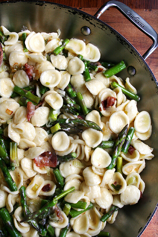 Flavored with leeks and lemons, this pasta carbonara is especially fresh and light. With bacon and eggs on hand, dinner can be thrown together in a flash. Add asparagus and you have a one-dish dinner on your hands. The sauce tastes incredibly creamy (despite containing no cream at all) and coats the pasta so well, making every bite especially delectable. // alexandracooks.com A pan of pasta carbonara with asparagus.