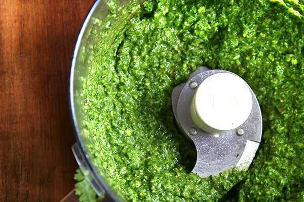 cuisinart with pesto Food processo with pesto sauce puréed.