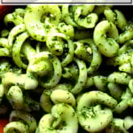 A bowl of pasta tossed in homemade pesto sauce.