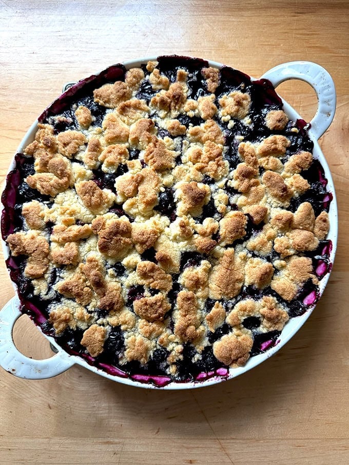 A gratin dish filled with Lemon-Blueberry Crisp. 