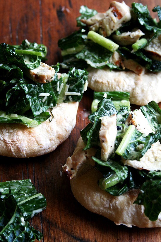 I'm planning a dinner party and thought it might be fun to make little flatbreads — "piadines" I saw them called — piled high with caesar salad — boring, I know, but perhaps made interesting by kale — tossed with sliced grilled chicken breasts — boring, I know, but chicken caesar kale salad is safe. I love this kind of thing, when bread and vegetable and meat are all wrapped up in one casual, fun, summery, light dish. // alexandracooks.com I'm planning a dinner party and thought it might be fun to make little flatbreads — "piadines" I saw them called — piled high with caesar salad — boring, I know, but perhaps made interesting by kale — tossed with sliced grilled chicken breasts — boring, I know, but chicken caesar kale salad is safe. I love this kind of thing, when bread and vegetable and meat are all wrapped up in one casual, fun, summery, light dish. // alexandracooks.com