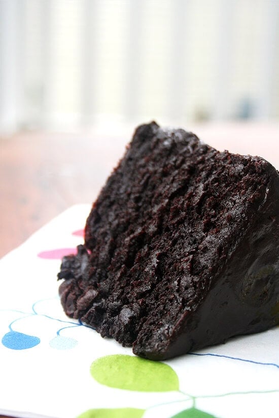 A slice of double chocolate cake with black velvet icing.