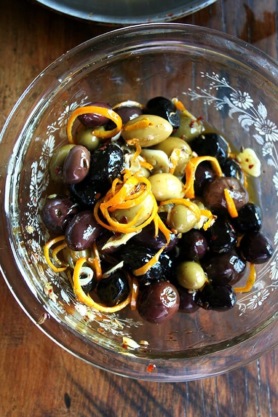 Marinated olives are about as easy as it gets as far as sprucing up the hors d'oeuvres spread goes โ a little garlic and orange zest along with a few spices (crushed red pepper flakes and fennel seed) go a long way, and these flavor elements look so pretty in the serving dish as well. // alexandracooks.com