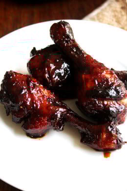A plate of oven-baked, honey-soy chicken drumsticks.