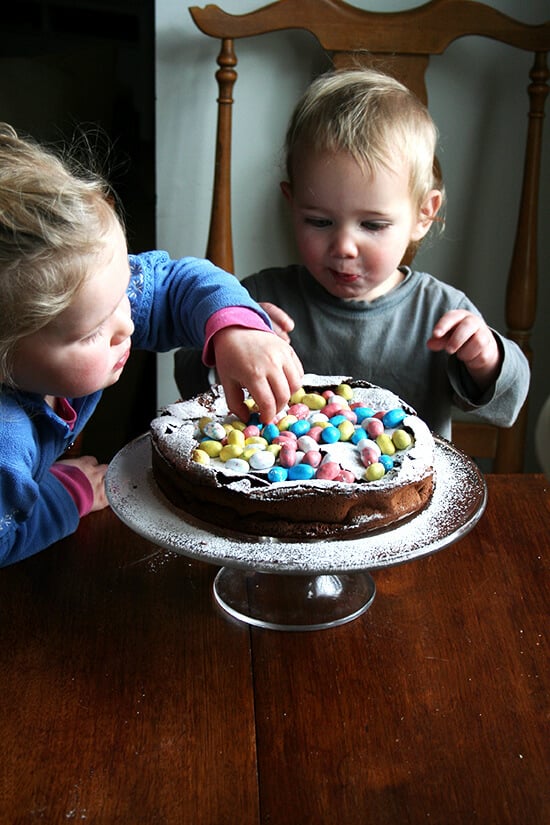 This rich chocolate Easter egg nest cake is festive and fun, puffing way up when it bakes and sinking when it cools, a crackly meringue-like layer forming a perfect base to house dozens of colorful candy eggs. // alexandracooks.com This rich chocolate Easter egg nest cake is festive and fun, puffing way up when it bakes and sinking when it cools, a crackly meringue-like layer forming a perfect base to house dozens of colorful candy eggs. // alexandracooks.com