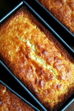 An overhead shot of a mini loaf pan filled with just-baked lemon-ricotta pound cake.