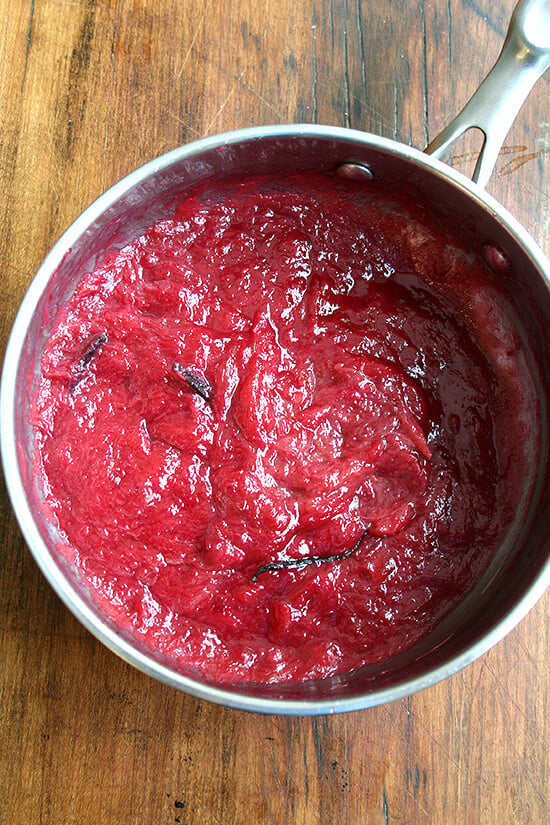 A saucepan filled with cooked rhubarb jam.