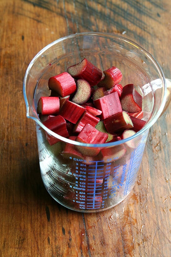 A measuring cup filled with chopped rhubarb.