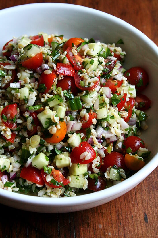With little more than a knife, a cutting board, and a large bowl, a beautiful whole grain salad can materialize in no time. Tabbouleh, a dish my mother made for us all summer long for as long as I can remember, a dish that feels at once light, satisfying and nourishing. With some warm pita and a block of feta, dinner is served. // alexandracooks.com A bowl of tabbouleh.