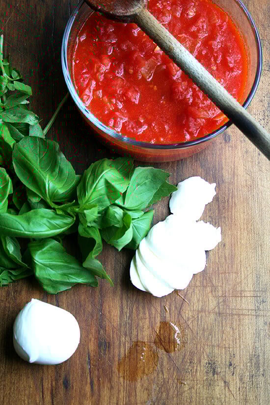 Margherita pizza toppings: sauce, basil, fresh mozzarella. 