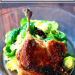 A plate with cheater's duck confit on top aside a salad.