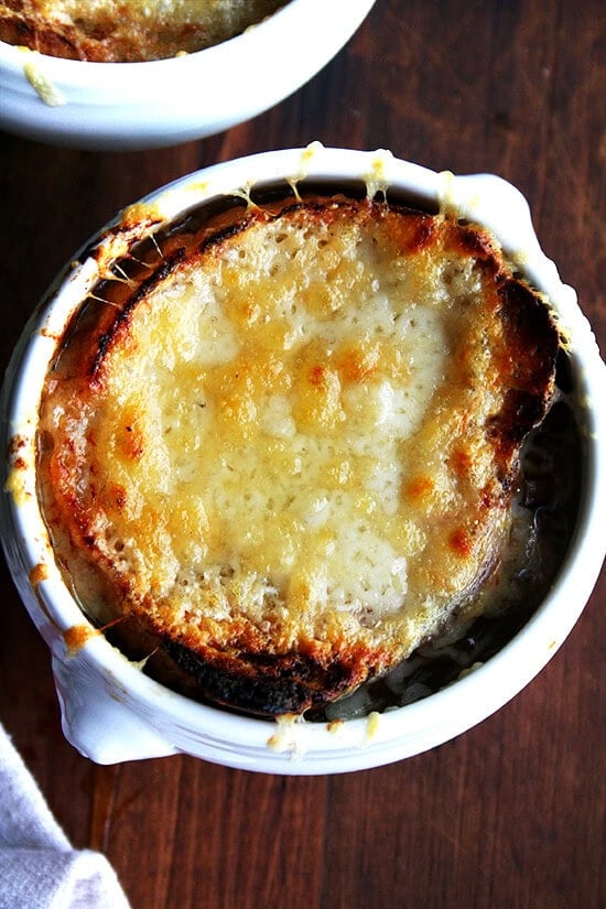 Two bowls of French onion soup, just broiled. 