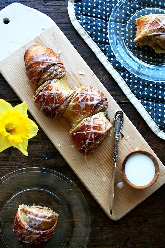 This is my favorite cinnamon pull-apart bread. The loaf stretches from corner to corner of the sheetpan and oozes with cinnamon and sugar upon baking. You'll tuck in immediately, pulling at the nearest coil, spreading cream cheese icing over each bite, eating and talking and sipping coffee until not a crumb remains. // alexandracooks.com cinnamon pull-apart bread on a board.