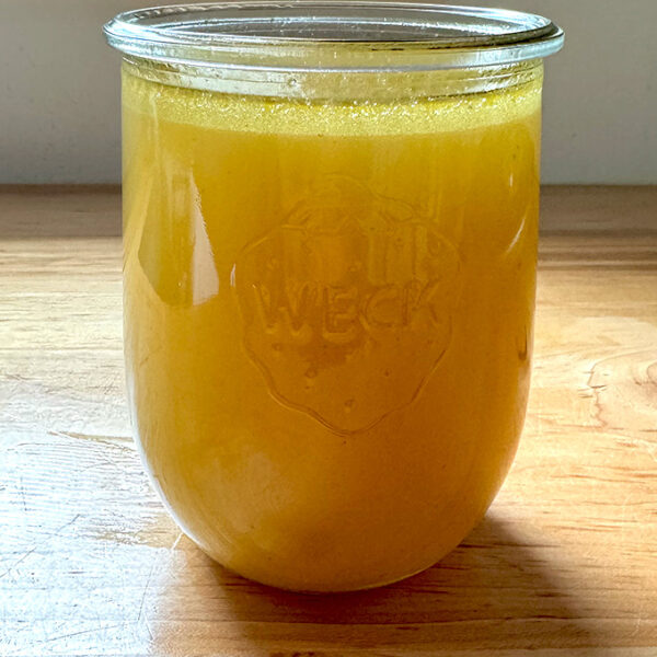 A Weck Jar filled with homemade chicken stock.