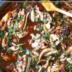 A skillet filled with chicken tinga.