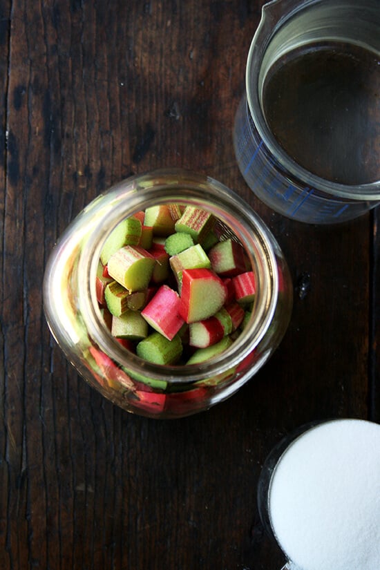 Overhead shot of rhubarb schnapps ingredients: chopped rhubarb, sugar, vodka.