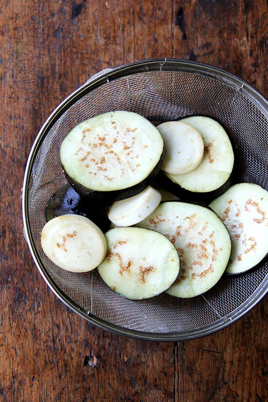 salted eggplant draining in a colander