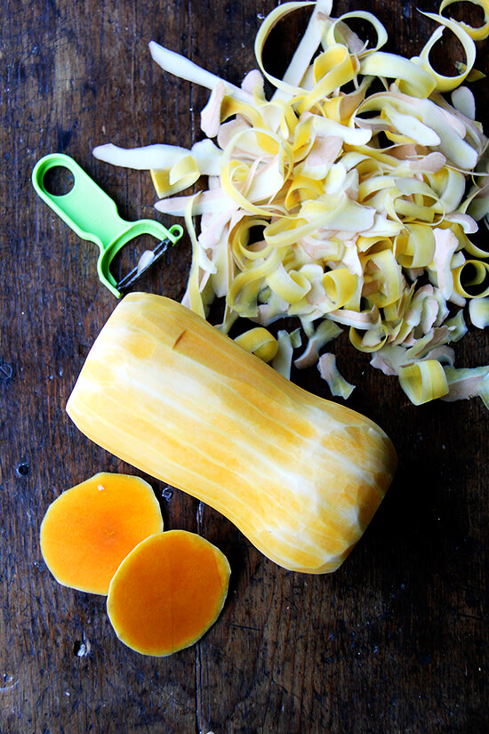 A peeled butternut squash and all the trimmings.