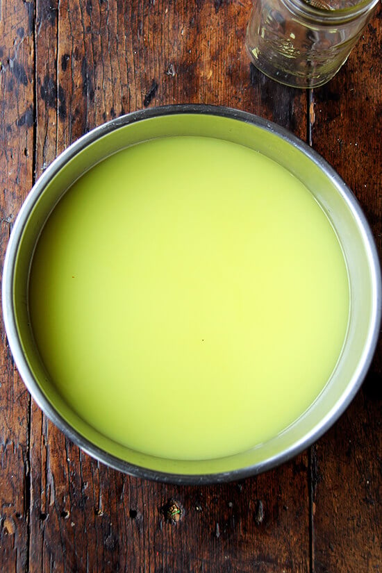 A large bowl filled with simple syrup and lemon-infused grain alcohol.