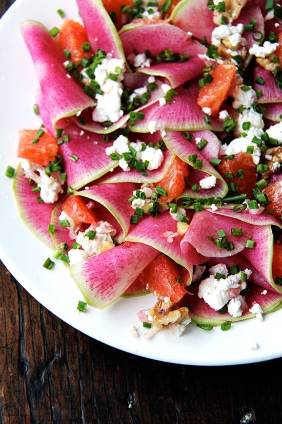 This beautiful salad is a mix of paper-thin watermelon radishes, Cara Cara oranges — so sweet and pretty — toasted walnuts and goat cheese, dressed with shallots macerated in vinegar, olive oil, and chives. If you don't have radishes on hand, turnips work, too, and so do beets (cooked first, though raw might be interesting? and messy?). // alexandracooks.com Watermelon radish, goat cheese, chives, and walnut salad.