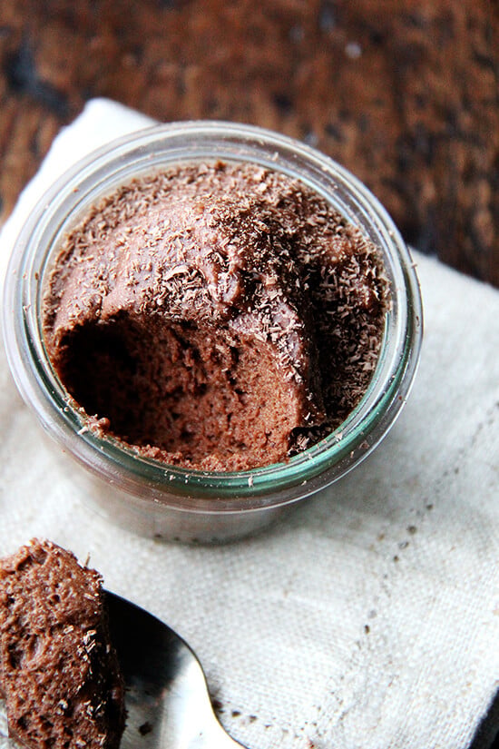 Chocolate mousse is a great make-ahead recipe if you plan on spending Valentine's Day at home, and, Valentine's Day calls for chocolate, right? This recipe doesn't just taste like chocolate-flavored whipped cream. It has body with a lightness coming exclusively from beaten egg whites. // alexandracooks.com An overhead shot of a small glass of chocolate mousse aside a spoon.
