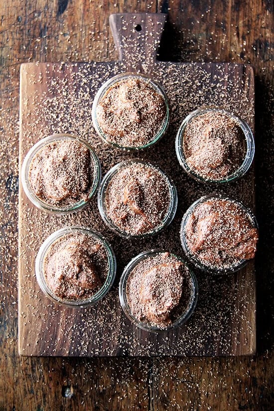 Chocolate mousse is a great make-ahead recipe if you plan on spending Valentine's Day at home, and, Valentine's Day calls for chocolate, right? This recipe doesn't just taste like chocolate-flavored whipped cream. It has body with a lightness coming exclusively from beaten egg whites. // alexandracooks.com An overhead shot of jars filled with chocolate mousse and topped with chocolate shavings.
