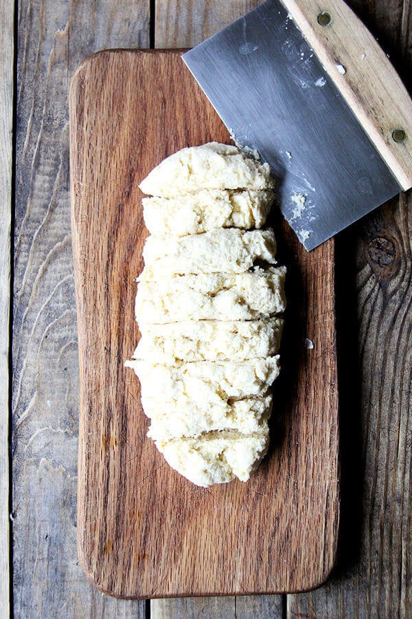 A board with biscuit dough cut into portions.