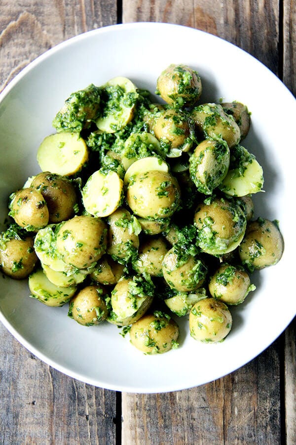 The green harissa on these new potatoes is a vegan, gluten-, dairy- and nut-free recipe capable of basking on a sun-strewn buffet table for hours. The upshot of puréeing herbs with garlic, olive oil and some sort of acid is a sharp, vibrant sauce fit for dressing up any boiled root vegetable, uniting disparate ingredients in a grain bowl, or drizzling over roast chicken or grilled fish. // alexandracooks.com The green harissa on these new potatoes is a vegan, gluten-, dairy- and nut-free recipe capable of basking on a sun-strewn buffet table for hours. The upshot of puréeing herbs with garlic, olive oil and some sort of acid is a sharp, vibrant sauce fit for dressing up any boiled root vegetable, uniting disparate ingredients in a grain bowl, or drizzling over roast chicken or grilled fish. // alexandracooks.com