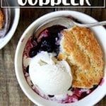 A bowl of blueberry cobbler with ice cream.