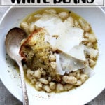 A bowl of stewy white beans.