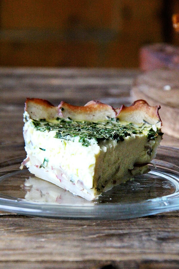 In any incarnation — made in its entirety with a flaky, buttery pastry shell or without a crust altogether and loaded with kale — the Tartine quiche is a treat. But this latest variation, which is just slightly more work than its crustless predecessor, may be my favorite yet. The potato crust is so tasty, so pretty, and, if you own a mandoline, easy to assemble, too. // alexandracooks.com A slice of potato-crusted quiche.