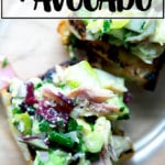 An overhead shot of a smoked trout and avocado salad on toasty bread.