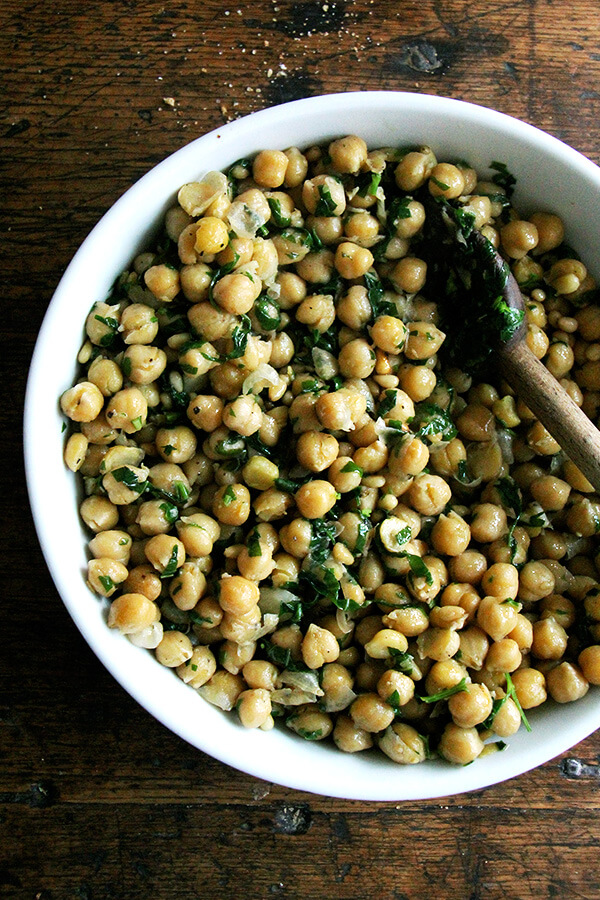 This recipe for chickpea saute with basil and pine nuts is inspired by the beautiful basil that has been arriving in our CSA: sweat garlic in extra-virgin olive oil, add cooked chickpeas, toasted pine nuts, and lots of salt, pepper, and chopped basil; sauté briefly; and serve immediately. Last Friday evening, a few friends came over for dinner, and we ate these chickpeas with grilled whole Branzino, focaccia, and a simple salad — it was a nice summer meal. // alexandracooks.com This recipe for chickpea saute with basil and pine nuts is inspired by the beautiful basil that has been arriving in our CSA: sweat garlic in extra-virgin olive oil, add cooked chickpeas, toasted pine nuts, and lots of salt, pepper, and chopped basil; sauté briefly; and serve immediately. Last Friday evening, a few friends came over for dinner, and we ate these chickpeas with grilled whole Branzino, focaccia, and a simple salad — it was a nice summer meal. // alexandracooks.com