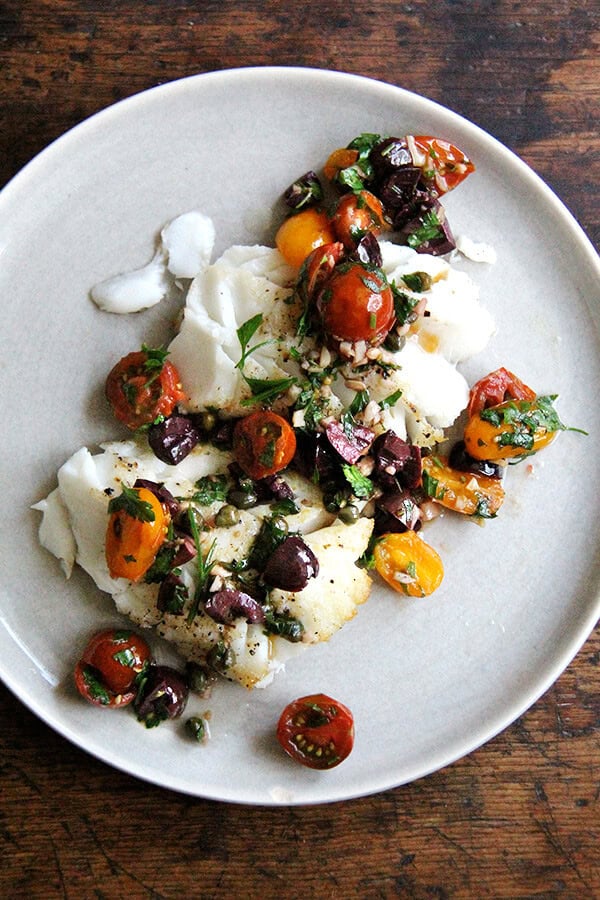 After halving a cup's worth of cherry tomatoes, mincing a clove of garlic, and coarsely chopping olives and parsley, this sauce Nicoise comes together in about 5 minutes, which means this could be on your dinner table tonight. // alexandracooks.com A plate of pan-seared cod with Sauce Nicoise.