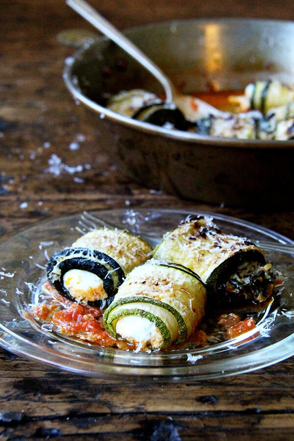 In this zucchini involtini, the ricotta filling is mixed with sautéed chard and lemon zest, but I've had success using leftover fresh corn polenta, chopped up roasted red peppers, and cubes of mozzarella, which makes me think the possibilities for involtini are endless. // alexandracooks.com A plate of zucchini involtini.