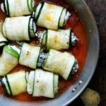 A pan of unbaked zucchini involtini.