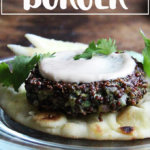 A plate topped with a crispy quinoa cake and tahini sauce.
