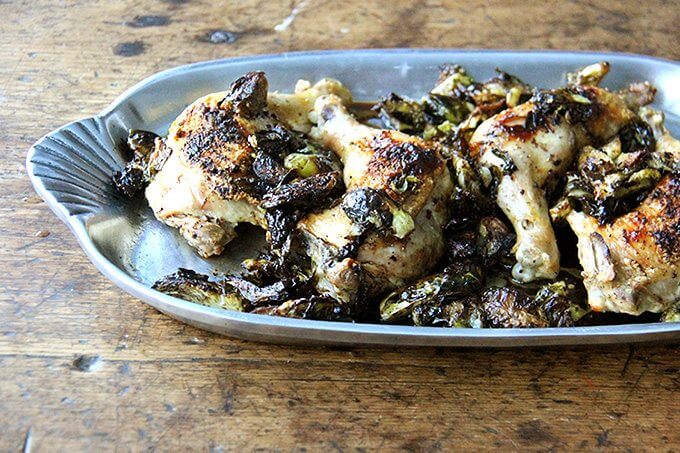 A platter of sheet pan chicken and Brussels sprouts.