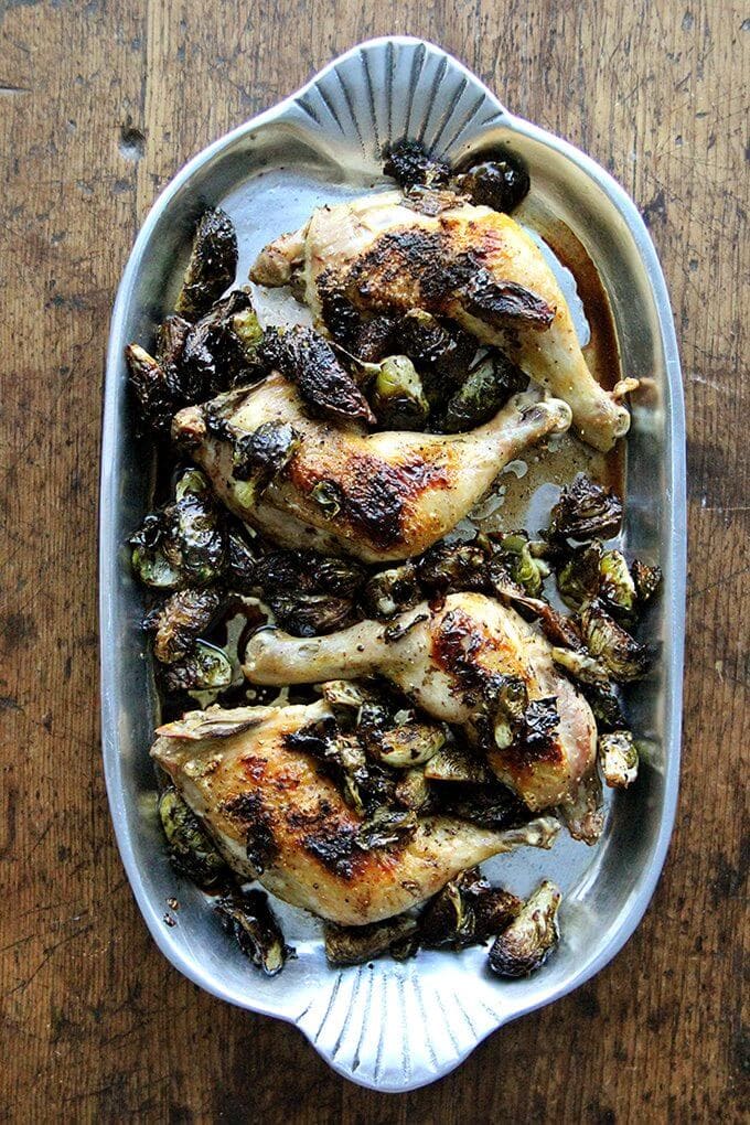In this roast chicken with Brussels sprouts recipe, after roasting chicken legs, the emptied pan gets hit with a few tablespoons of syrupy balsamic vinegar, which not only deglazes it, but also provides that bite so often welcomed by the cabbage family of vegetables. // alexandracooks.com A platter of sheet pan roast chicken and balsamic Brussels sprouts.